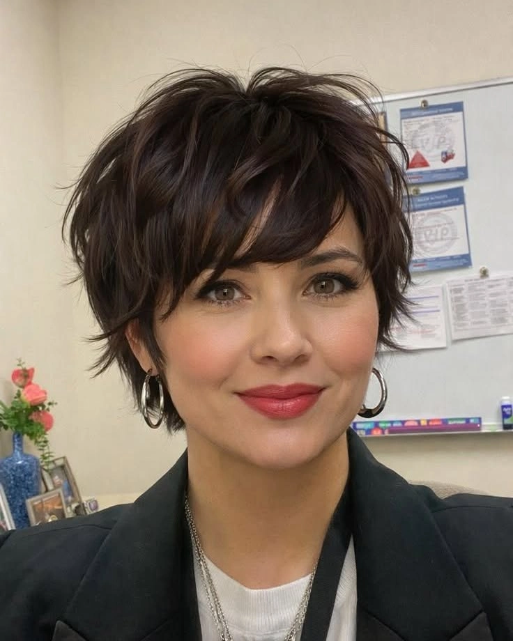 Soft layered pixie with a side-swept fringe on fine dark hair