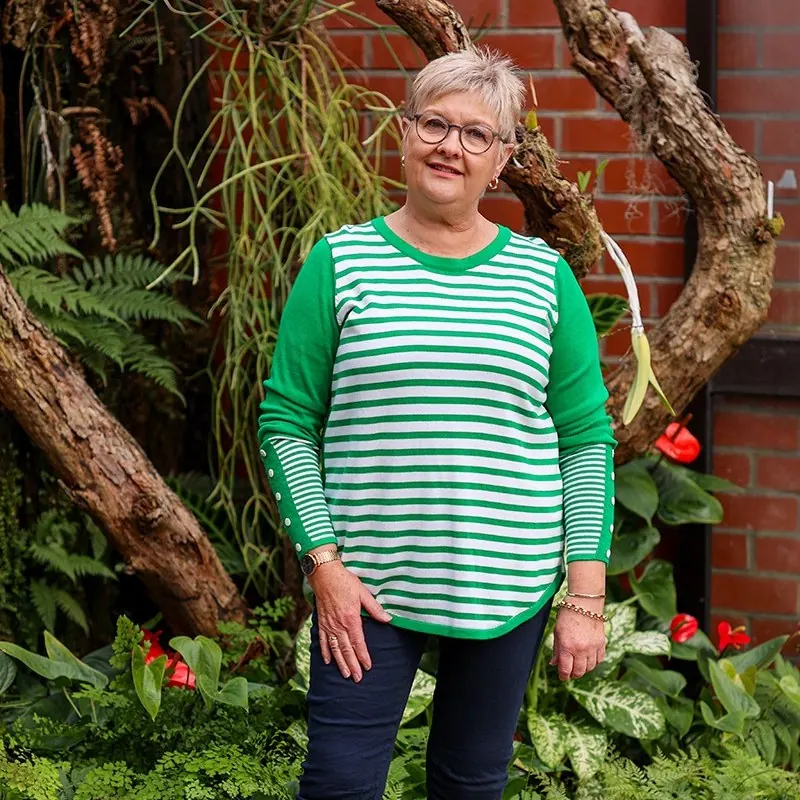 Short grey crop styled to work with round glasses on a woman over 60